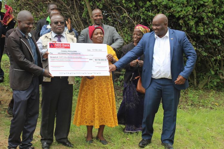 Changu Cooperative in Kasungu with First Deputy Speaker of Malawi Parliament smile over the dummy cheque